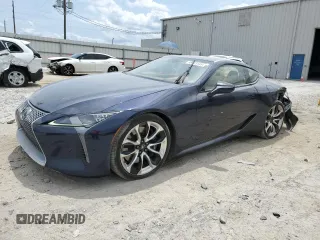 2021 Lexus LC 500h с VIN JTHBP5AY2MA100332, выставлен на аукционе Copart как лот 56463145 с пробегом 33 589 миль миль и Списание • Salvage title. История ставок и продаж доступна на DreamBid. Изображение 1.