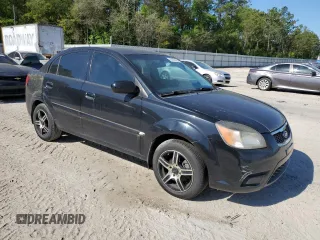 2011 Kia Rio LX with VIN KNADH4A31B6749736, listed as a Copart auction lot 53128685 with 103,392 mi miles and Clean Title. Bid and sale history available at carsss.com. Image 4.