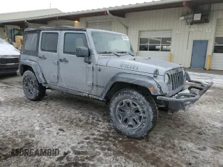 2015 Jeep Wrangler Unlimited Willys Wheeler with VIN 1C4BJWDG9FL516493, listed as a Copart auction lot 45098345 with 152,009 mi miles and Salvage Title. Bid and sale history available at DreamBid. Image 4.