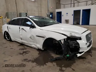 2014 Jaguar XJ Portfolio with VIN SAJWJ2GD2E8V69597, listed as a Copart auction lot 57798145 with 100,857 mi miles and Salvage title. Bid and sale history available at DreamBid. Image 4.