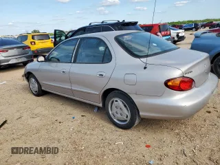 1999 Hyundai Elantra z VIN KMHJF25F1XU777099, wystawiony jako Copart lot #58870035 z przebiegiem 69 470 mil mil oraz Czysty tytuł • Clean title. Historia ofert i sprzedaży dostępna na DreamBid. Obrazek 2.