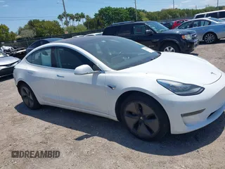 2018 Tesla Model 3 Long Range Battery with VIN 5YJ3E1EAXJF027179, listed as a IAAI auction lot 42059918 with 43,566 mi miles. Bid and sale history available at carsss.com. Image 1.