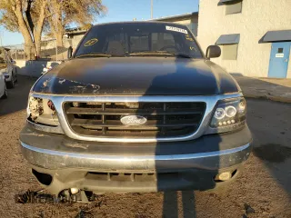 2002 Ford F-150 XL with VIN 1FTRF18262NB35586, listed as a Copart auction lot 77114114 with 166,942 mi miles and Salvage title. Bid and sale history available at DreamBid. Image 5.