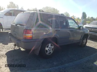 1995 Jeep Grand Cherokee Laredo with VIN 1J4FX58S1SC754691, listed as a Copart auction lot 72858214 with 251,234 mi miles and Salvage Title. Bid and sale history available at carsss.com. Image 3.