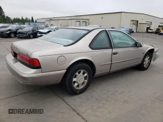 1995 Ford Thunderbird LX with VIN 1FALP62W45H169199, listed as a Copart auction lot 65458964 with 111,726 mi miles and Salvage Title. Bid and sale history available at DreamBid. Image 3.