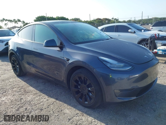 2023 Tesla Model Y Long Range z VIN 7SAYGDEE5PA099226, wystawiony jako IAAI lot #42004061 z przebiegiem 10 607 mil mil oraz . Historia ofert i sprzedaży dostępna na DreamBid. Obrazek 1.
