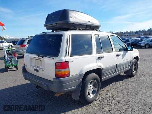 1996 Jeep Grand Cherokee Laredo z VIN 1J4GZ58Y5TC186403, wystawiony jako IAAI lot #41562270 z przebiegiem 205 797 mil mil oraz . Historia ofert i sprzedaży dostępna na DreamBid. Obrazek 4.