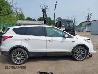 2014 Ford Escape SE with VIN 1FMCU9G99EUC81141, listed as a IAAI auction lot 42436279 with 123,947 mi miles and . Bid and sale history available at DreamBid. Image 13.