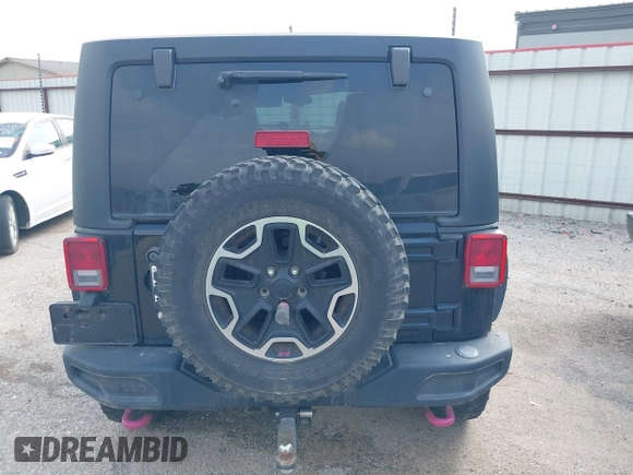 2015 Jeep Wrangler Unlimited Rubicon z VIN 1C4BJWFG2FL572417, wystawiony jako IAAI lot #41895927 z przebiegiem 54 981 mil mil oraz . Historia ofert i sprzedaży dostępna na DreamBid. Obrazek 16.