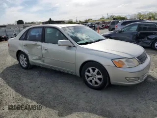2000 Toyota Avalon XL with VIN 4T1BF28B3YU002835, listed as a Copart auction lot 50902115 with 128,699 mi miles and Salvage Title. Bid and sale history available at DreamBid. Image 4.