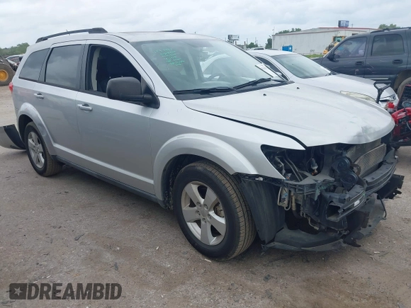 2013 Dodge Journey SE z VIN 3C4PDCAB9DT529668, wystawiony jako IAAI lot #42130654 z przebiegiem 156 472 mil mil oraz . Historia ofert i sprzedaży dostępna na DreamBid. Obrazek 1.