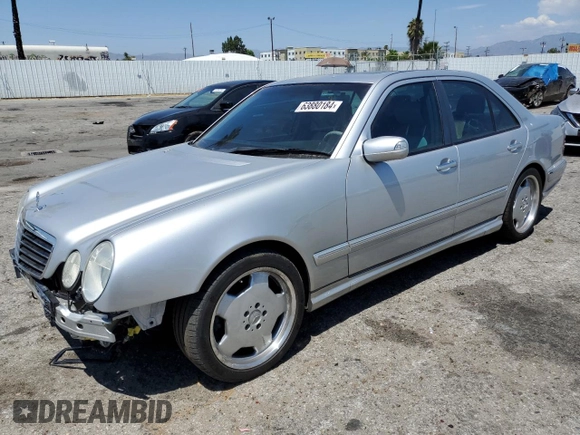 2000 Mercedes-Benz E with VIN WDBJF74J7YB055624, listed as a Copart auction lot 63880184 with 71,355 mi miles and Salvage Title. Bid and sale history available at DreamBid. Image 1.