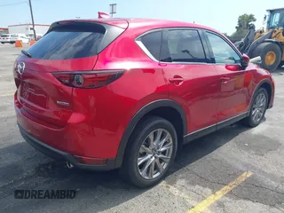 2021 Mazda CX-5 Grand Touring with VIN JM3KFADM6M1373111, listed as a IAAI auction lot 42784431 with 14,374 mi miles and . Bid and sale history available at DreamBid. Image 4.