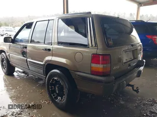 1995 Jeep Grand Cherokee Laredo with VIN 1J4GZ58SXSC697003, listed as a IAAI auction lot 41259889 with 248,595 mi miles. Bid and sale history available at carsss.com. Image 3.