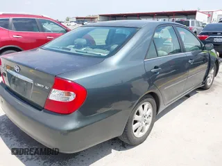 2002 Toyota Camry LE z VIN 4T1BE30KX2U591037, wystawiony jako IAAI lot #42077641 z przebiegiem 86 569 mil mil oraz . Historia ofert i sprzedaży dostępna na DreamBid. Obrazek 4.