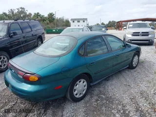 1997 Ford Taurus GL with VIN 1FALP52U8VA147714, listed as a IAAI auction lot 40781743 with 57,823 mi miles. Bid and sale history available at carsss.com. Image 4.
