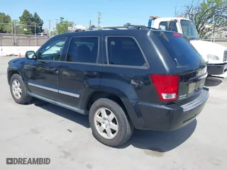 2010 Jeep Grand Cherokee Laredo with VIN 1J4PR4GK2AC104857, listed as a IAAI auction lot 42009569 with 131,986 mi miles. Bid and sale history available at carsss.com. Image 3.