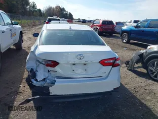2020 Toyota Camry LE with VIN 4T1C11AKXLU986310, listed as a IAAI auction lot 40977100 with 108,208 mi miles and . Bid and sale history available at DreamBid. Image 16.
