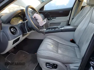 2014 Jaguar XJ Portfolio with VIN SAJWJ2GD5E8V69562, listed as a Copart auction lot 87737195 with 100,525 mi miles and Salvage title. Bid and sale history available at DreamBid. Image 7.