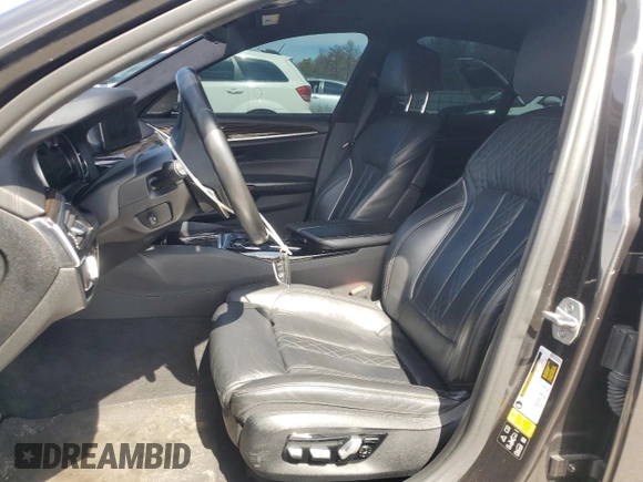 2018 BMW 5 Series M550i xDrive with VIN WBAJB9C57JB286734, listed as a Copart auction lot 52711235 with 127,450 mi miles and Salvage title. Bid and sale history available at DreamBid. Image 7.