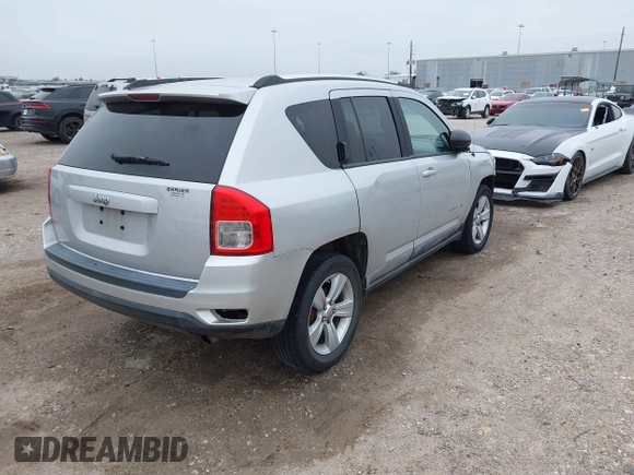 2011 Jeep Compass with VIN 1J4NT1FA7BD142600, listed as a IAAI auction lot 41590661 with 266,600 mi miles. Bid and sale history available at carsss.com. Image 4.