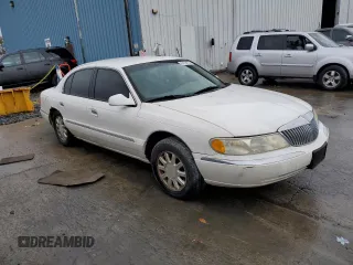 1999 Lincoln Continental with VIN 1LNHM97V3XY667567, listed as a Copart auction lot 84194854 with 137,163 mi miles and Salvage Title. Bid and sale history available at carsss.com. Image 4.