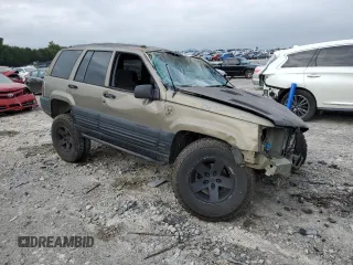 1996 Jeep Grand Cherokee Laredo with VIN 1J4GZ58S3TC297818, listed as a Copart auction lot 67712584 with 284,653 mi miles and Salvage Title. Bid and sale history available at carsss.com. Image 4.
