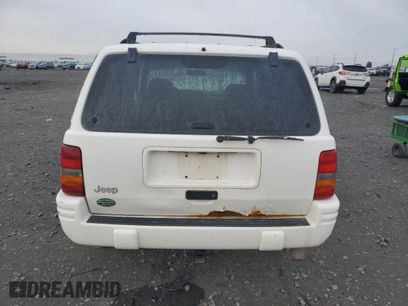1998 Jeep Grand Cherokee Laredo with VIN 1J4GZ48S1WC165851, listed as a Copart auction lot 84110044 with 306,484 mi miles and Salvage Title. Bid and sale history available at carsss.com. Image 6.