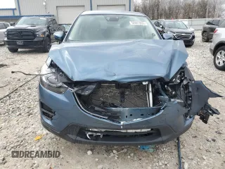 2016 Mazda CX-5 Grand Touring z VIN JM3KE4DY2G0637779, wystawiony jako Copart lot #52001805 z przebiegiem 184 381 mil mil oraz Czysty tytuł • Clean title. Historia ofert i sprzedaży dostępna na DreamBid. Obrazek 5.