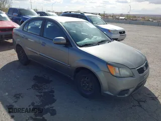 2010 Kia Rio LX with VIN KNADH4A34A6674027, listed as a IAAI auction lot 41804686 with 113,528 mi miles. Bid and sale history available at carsss.com. Image 1.