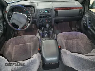 2000 Jeep Grand Cherokee Laredo with VIN 1J4GW48S2YC256123, listed as a Copart auction lot 56015855 with 147,549 mi miles and Salvage title. Bid and sale history available at DreamBid. Image 8.