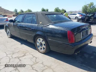 2002 Cadillac DeVille DTS z VIN 1G6KF579X2U134554, wystawiony jako IAAI lot #42244304 z przebiegiem 149 141 mil mil oraz . Historia ofert i sprzedaży dostępna na DreamBid. Obrazek 3.