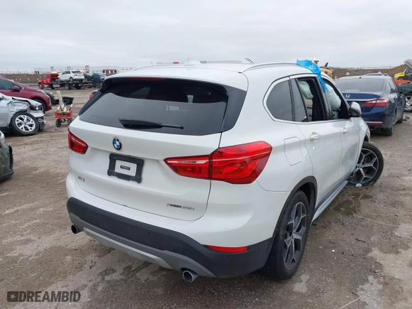 2019 BMW X1 xDrive28i with VIN WBXHT3C51K5L90392, listed as a IAAI auction lot 41571403 with 96,732 mi miles. Bid and sale history available at carsss.com. Image 4.
