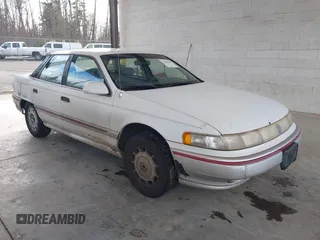 1992 Mercury Sable z VIN 1MECM5049NG647978, wystawiony jako IAAI lot #41805346 z przebiegiem 23 634 mil mil oraz . Historia ofert i sprzedaży dostępna na DreamBid. Obrazek 1.