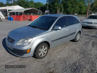 2009 Kia Rio LX with VIN KNADE243096440150, listed as a IAAI auction lot 42152589 with 114,484 mi miles. Bid and sale history available at carsss.com. Image 2.