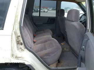 1996 Jeep Grand Cherokee Laredo with VIN 1J4FX58S1TC278511, listed as a IAAI auction lot 41837339 with 303,947 mi miles. Bid and sale history available at carsss.com. Image 8.
