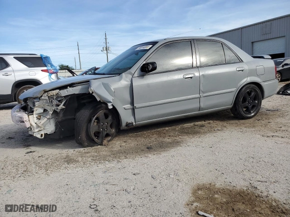 2000 Mazda Protege DX with VIN JM1BJ2221Y0310055, listed as a Copart auction lot 79814684 with 144,173 mi miles and Salvage Title. Bid and sale history available at carsss.com. Image 1.