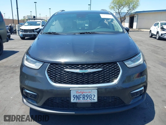 2021 Chrysler Pacifica Hybrid Touring L with VIN 2C4RC1L71MR599631, listed as a IAAI auction lot 42151965 with 67,401 mi miles and . Bid and sale history available at DreamBid. Image 12.