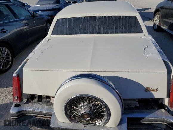 1985 Cadillac Eldorado z VIN 1G6EL5782FE630140, wystawiony jako Copart lot #76367454 z przebiegiem 29 850 mil mil oraz Szkody całkowita. Historia ofert i sprzedaży dostępna na DreamBid. Obrazek 6.