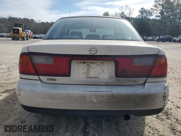 1998 Mazda Protege DX z VIN JM1BC1416W0194406, wystawiony jako Copart lot #44535955 z przebiegiem 312 942 mil mil oraz Szkoda całkowita • Salvage title. Historia ofert i sprzedaży dostępna na DreamBid. Obrazek 6.