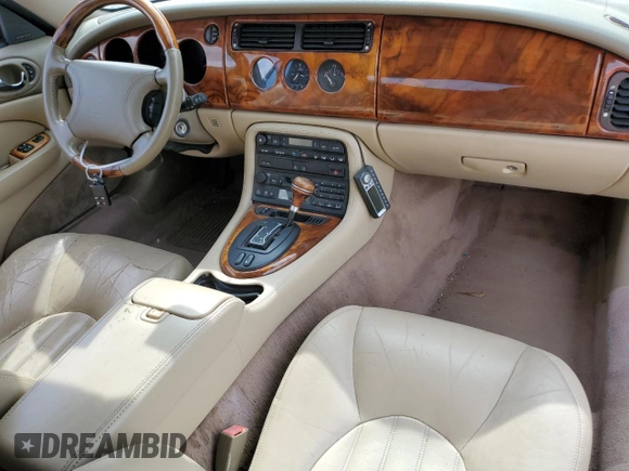 1999 Jaguar XK z VIN SAJGX2044XC031383, wystawiony jako Copart lot #54726925 z przebiegiem 107 696 mil mil oraz Szkody całkowita. Historia ofert i sprzedaży dostępna na DreamBid. Obrazek 8.