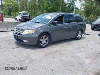 2013 Honda Odyssey Touring with VIN 5FNRL5H96DB068843, listed as a IAAI auction lot 42312176 with 115,804 mi miles and . Bid and sale history available at DreamBid. Image 2.