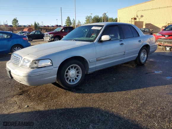 1999 Ford Crown Victoria LX with VIN 2FAFP74W8XX228696, listed as a Copart auction lot 87813965 with 201,576 mi miles and Salvage Title. Bid and sale history available at carsss.com. Image 1.