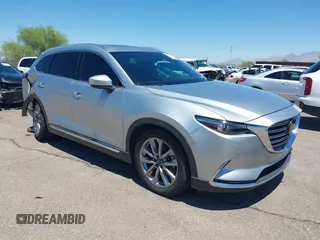 2021 Mazda CX-9 Grand Touring z VIN JM3TCADYXM0521606, wystawiony jako IAAI lot #42793746 z przebiegiem 41 777 mil mil oraz . Historia ofert i sprzedaży dostępna na DreamBid. Obrazek 1.