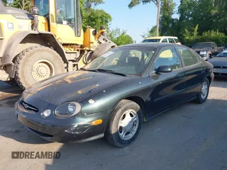 1999 Ford Taurus SE Comfort z VIN 1FAFP53S3XG104165, wystawiony jako IAAI lot #42234147 z przebiegiem 183 124 mil mil oraz . Historia ofert i sprzedaży dostępna na DreamBid. Obrazek 2.