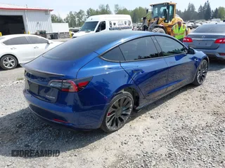 2021 Tesla Model 3 Performance with VIN 5YJ3E1EC1MF000961, listed as a IAAI auction lot 42110524 with 31,890 mi miles and . Bid and sale history available at carsss.com. Image 4.