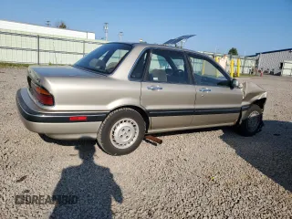 1989 Mitsubishi Galant with VIN JA3BR56V1KZ052149, listed as a Copart auction lot 69987544 with 74,232 mi miles and Salvage Title. Bid and sale history available at DreamBid. Image 3.