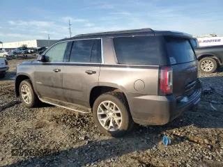 2015 GMC Yukon SLT with VIN 1GKS1BKC0FR735059, listed as a Copart auction lot 42960685 with 242,220 mi miles and Salvage Title. Bid and sale history available at carsss.com. Image 2.