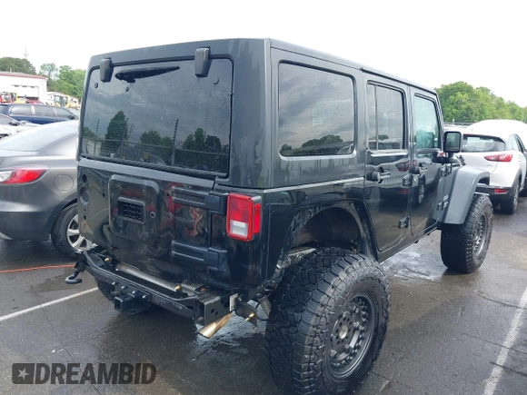 2015 Jeep Wrangler Unlimited Willys Wheeler with VIN 1C4BJWDG4FL687829, listed as a IAAI auction lot 42099147 with 98,969 mi miles and . Bid and sale history available at DreamBid. Image 4.