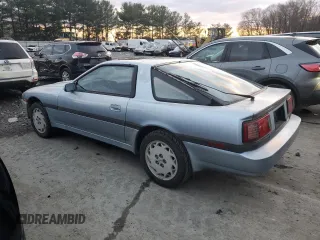 1986 Toyota Supra z VIN JT2MA70L4G0016772, wystawiony jako Copart lot #85806484 z przebiegiem 128 504 mil mil oraz Czysty tytuł • Clean title. Historia ofert i sprzedaży dostępna na DreamBid. Obrazek 2.